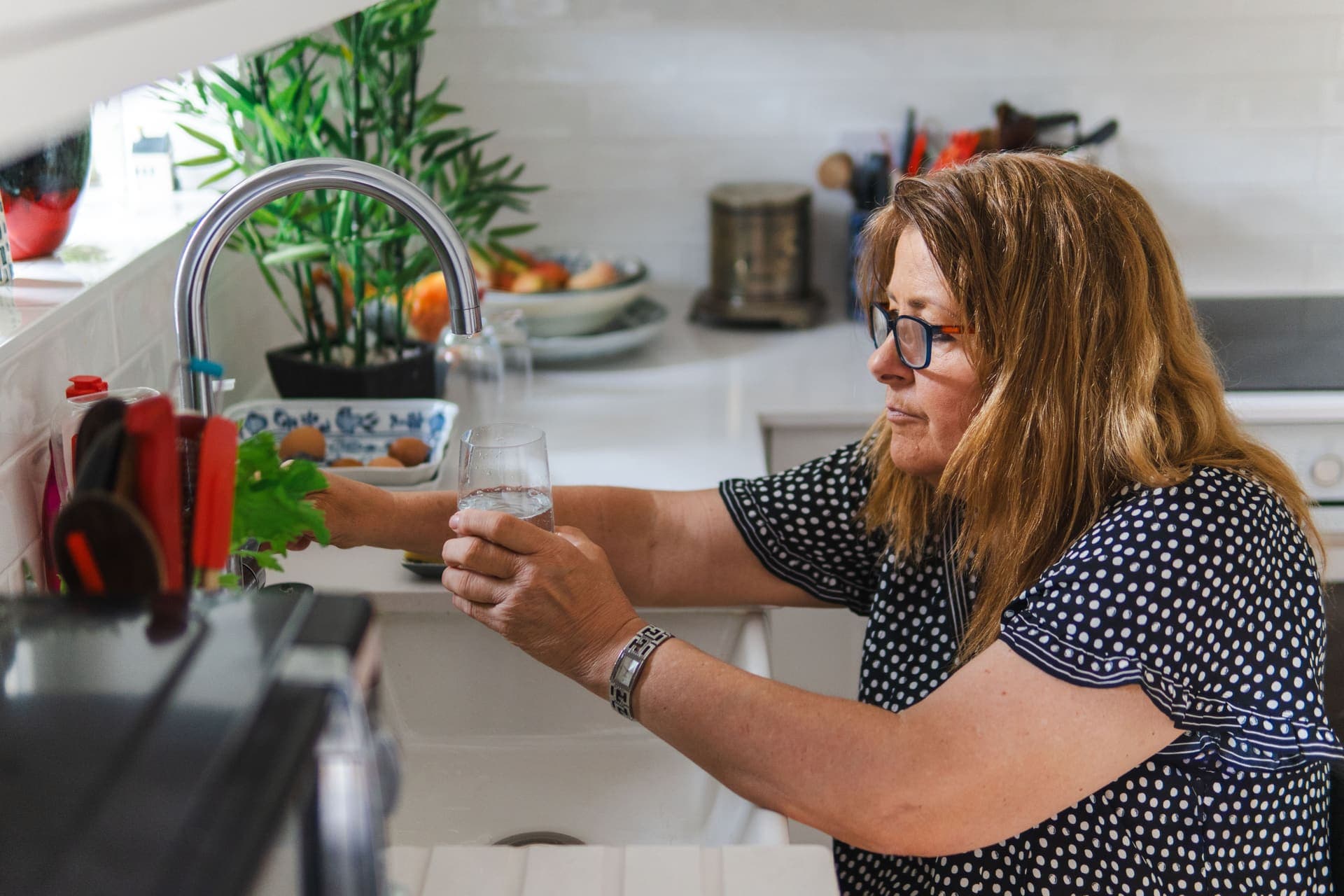 A glass of filtered water on a kitchen counter