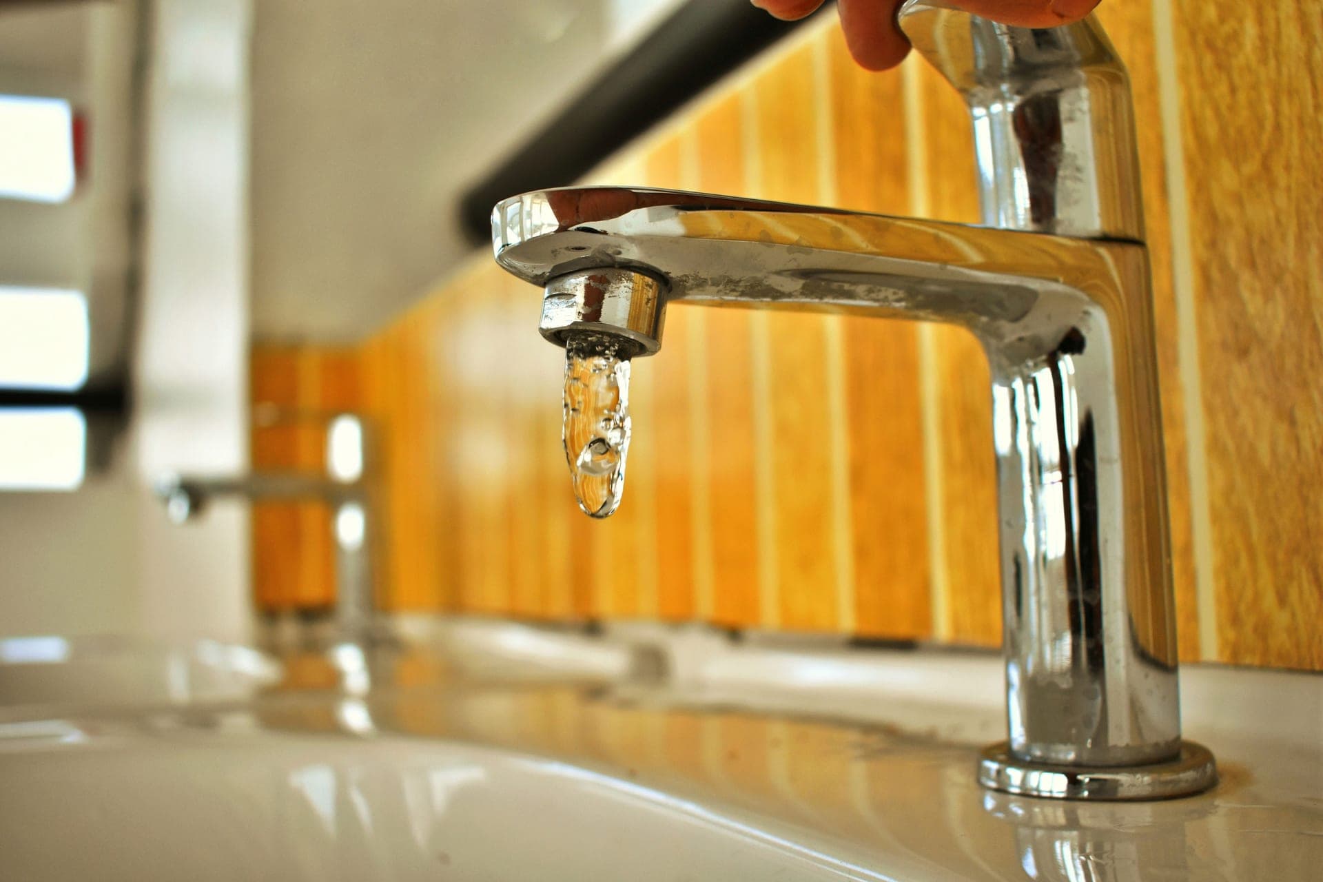 Kitchen faucet with water running into a sink