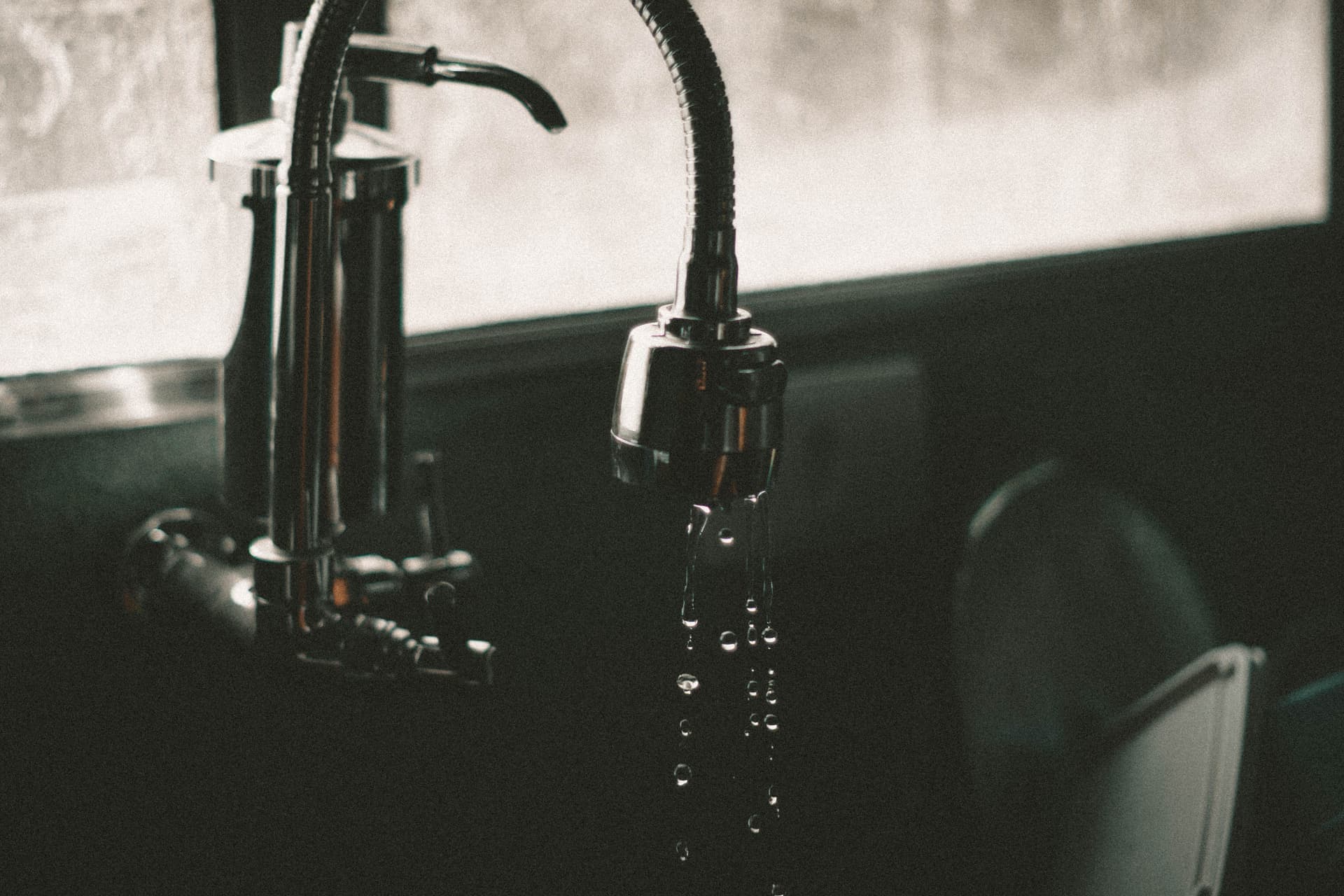 Water running from a kitchen faucet in close-up