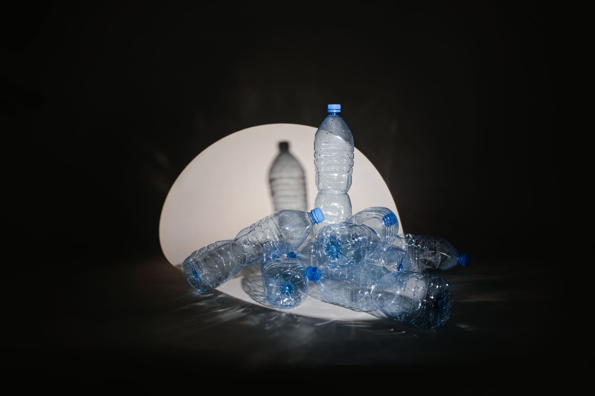 Plastic bottles lit against a dark background