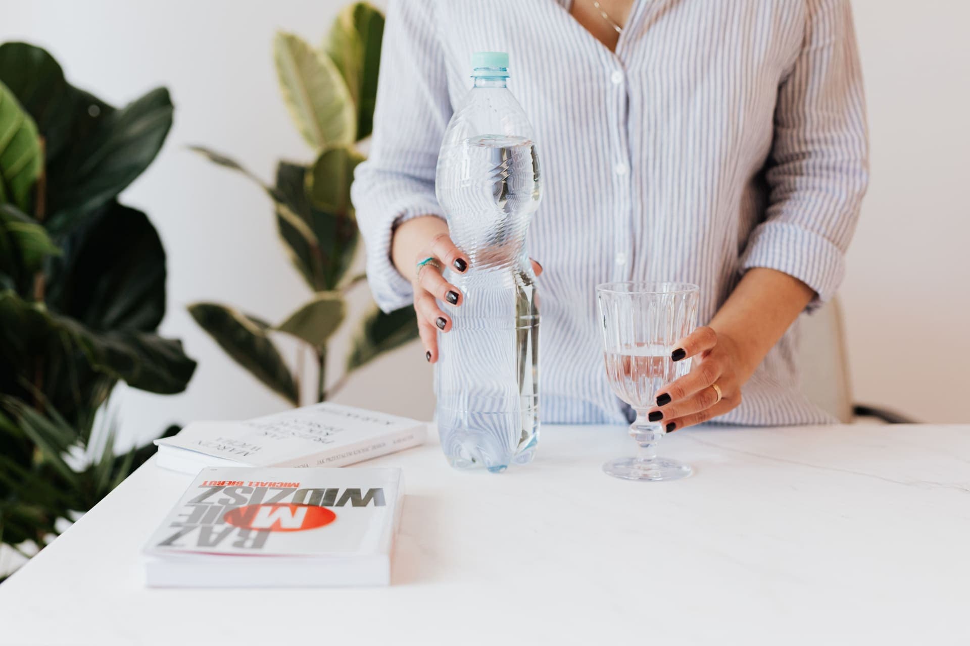 A glass and bottle of water on a table