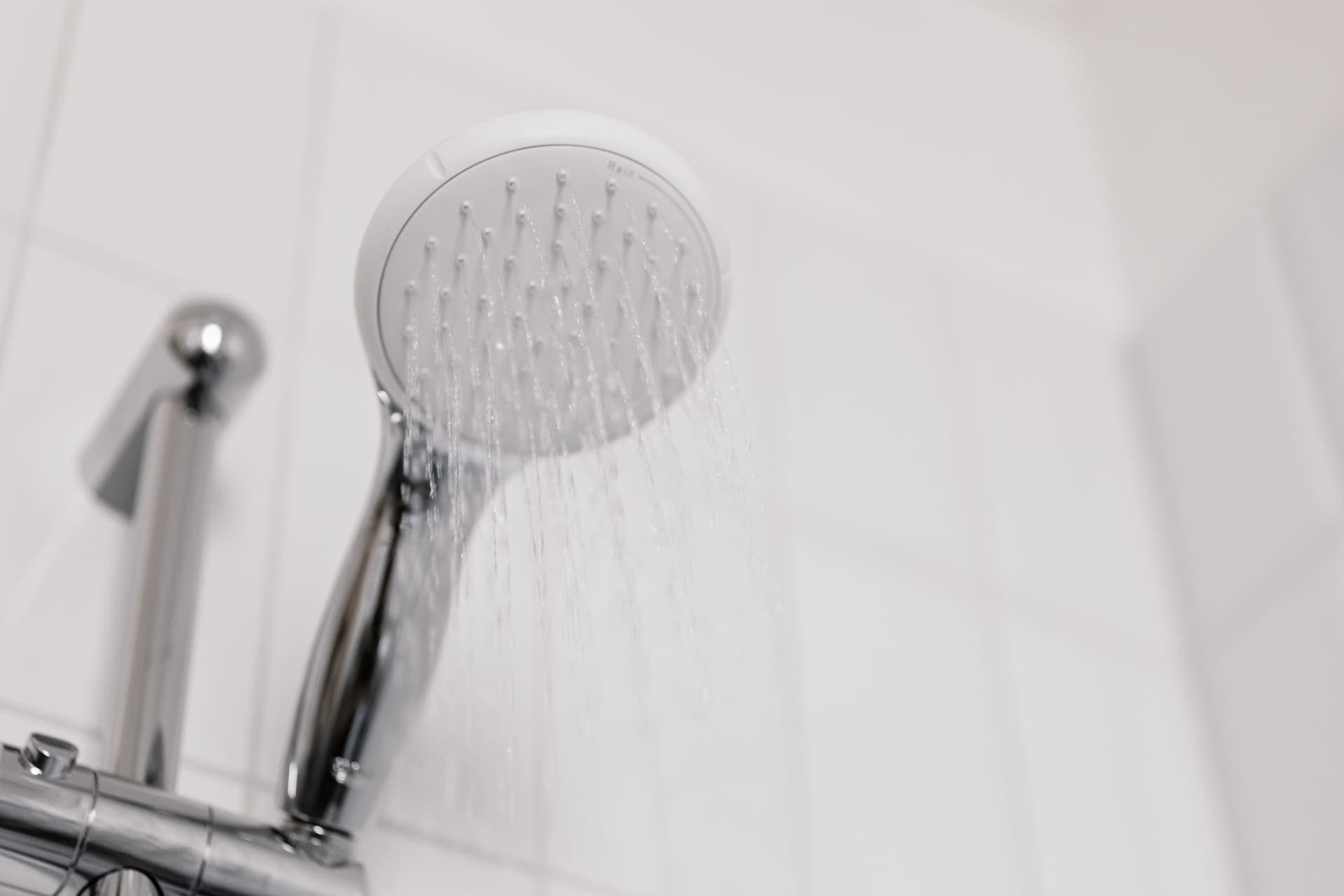 Water falling from a chrome shower head